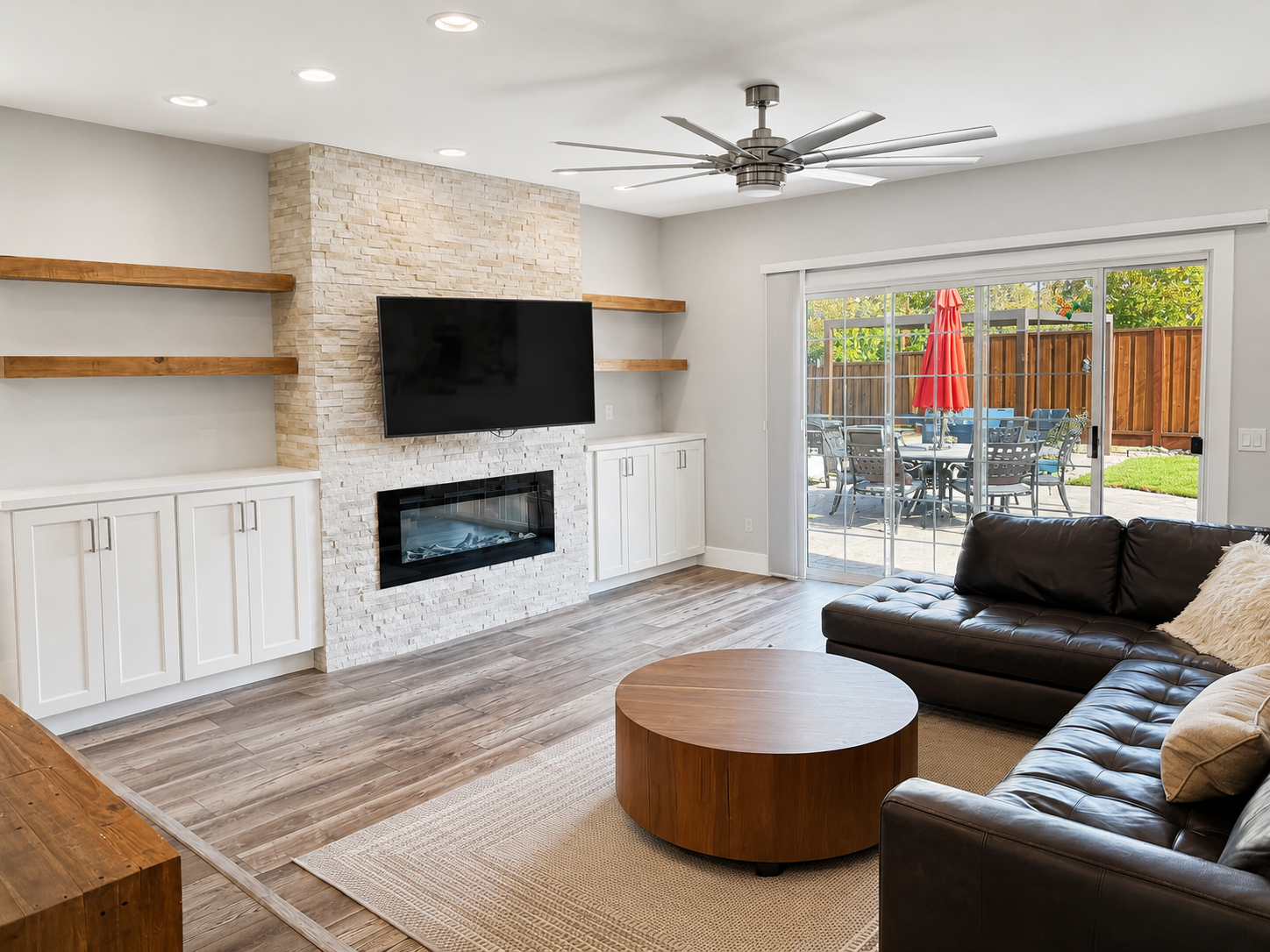 Living room after — neutral whites, clutter cleared, patio legible.